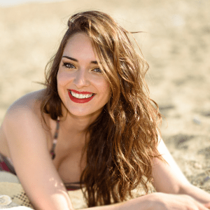 Young woman on beach with beach-wavey hair